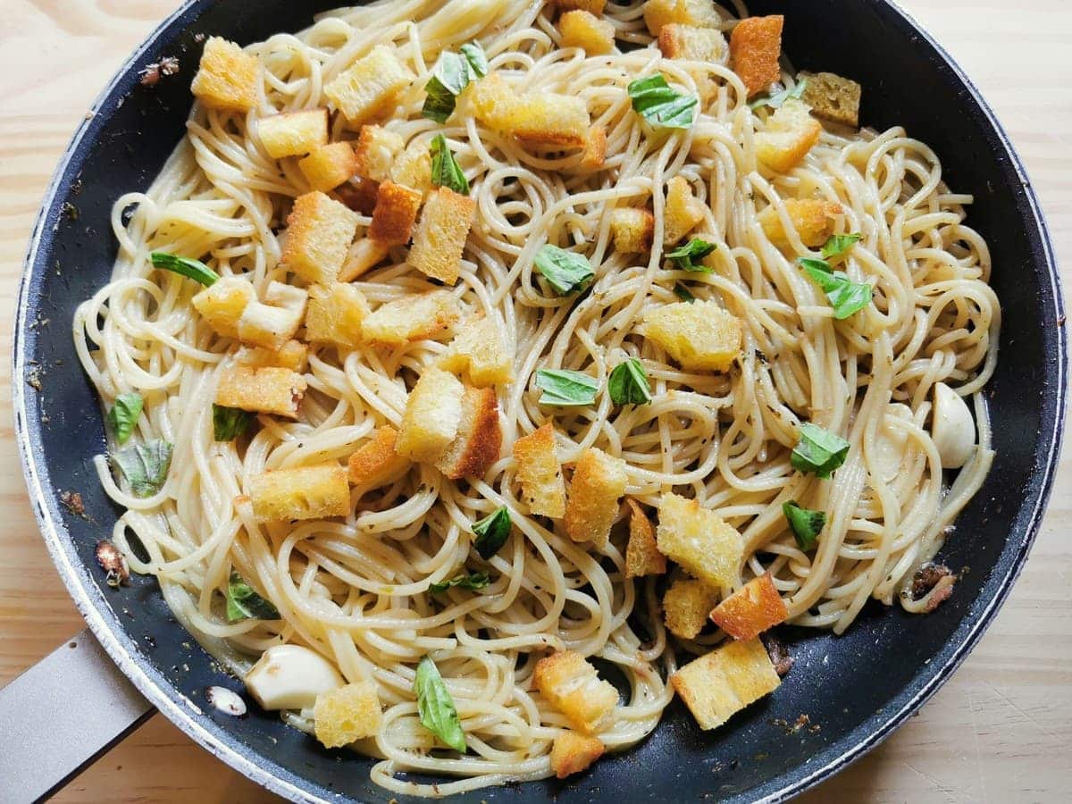 Spaghetti alla gennaro anchovy pasta from Naples in skillet ready to be served.
