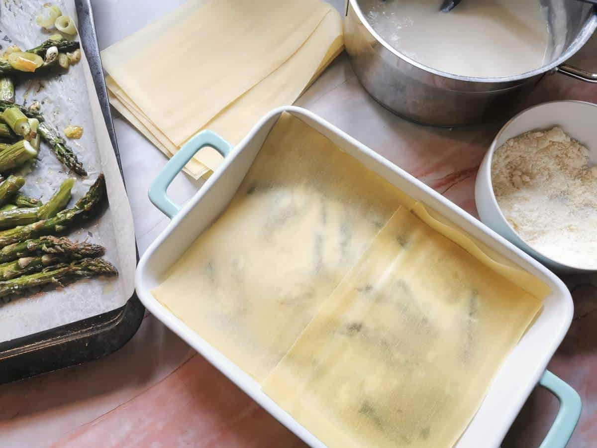A second layer of lasagne sheets on top  of other ingredients in oven dish.
