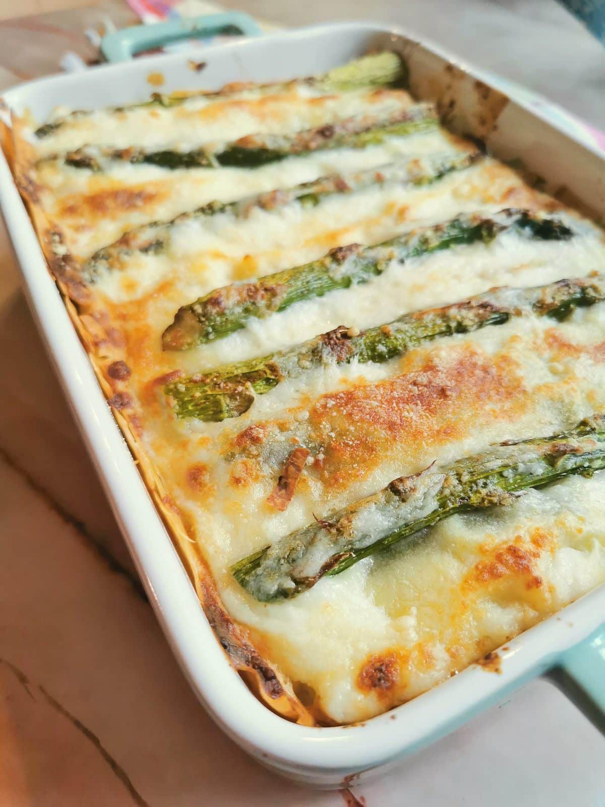 Asparagus lasagna (lasagne agli asparagi) in oven dish ready to serve.