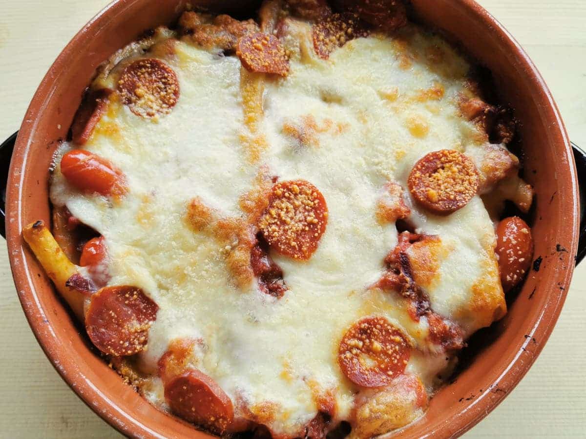 Baked ziti or zitoni pasta with spicy sausage.