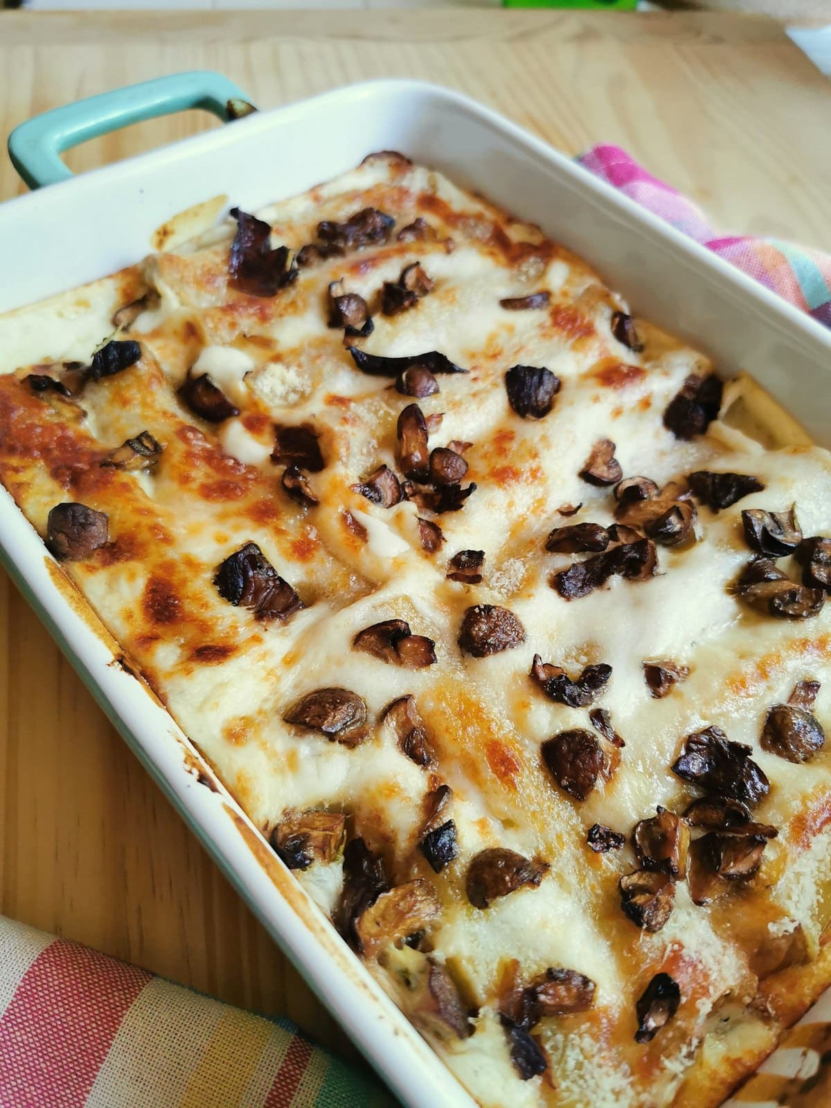 Mushroom cannelloni on a wooden table.
