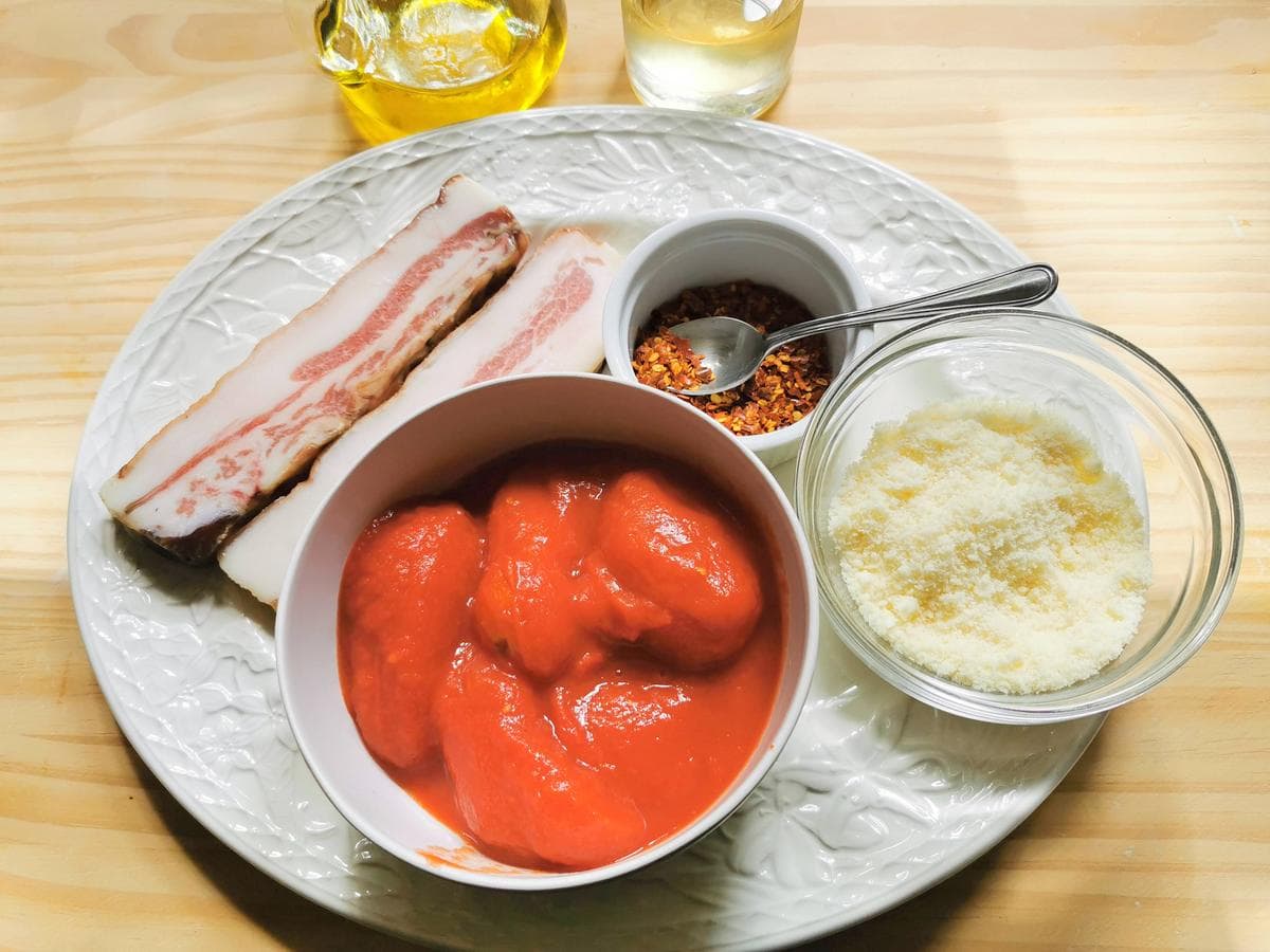 Ingredients for the pasta all’amatriciana on a kitchen table.
