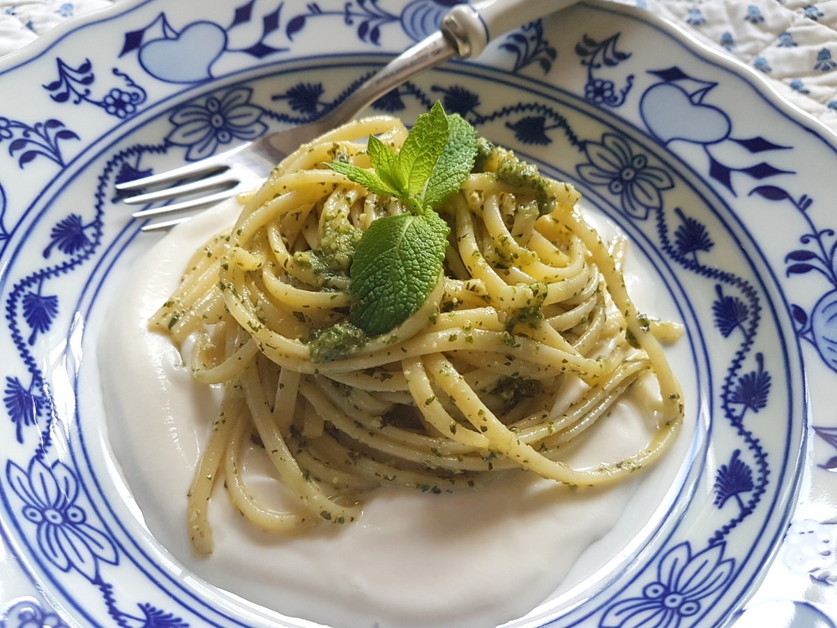 Mint pesto pasta on top of ricotta cream.