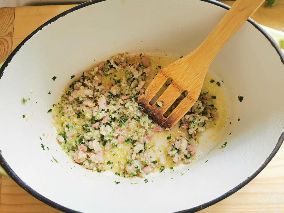 The guanciale, garlic, onion, celery and parsley paste in Duch oven with olive oil.