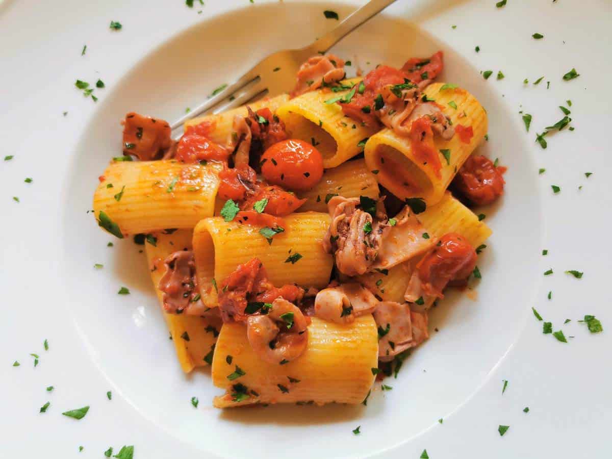 Seafood pasta recipe with calamari and tomatoes.