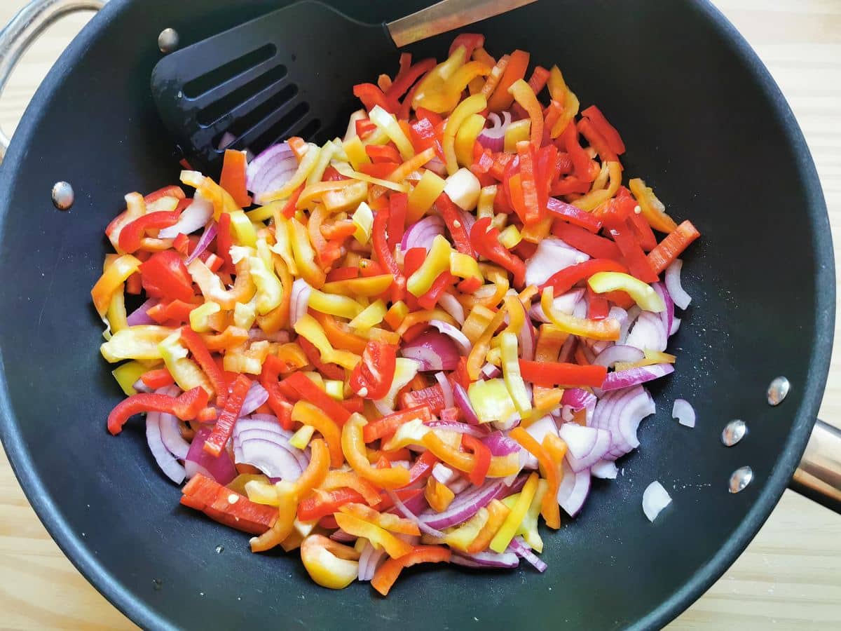 Peppers, onions and garlic in a pan.
