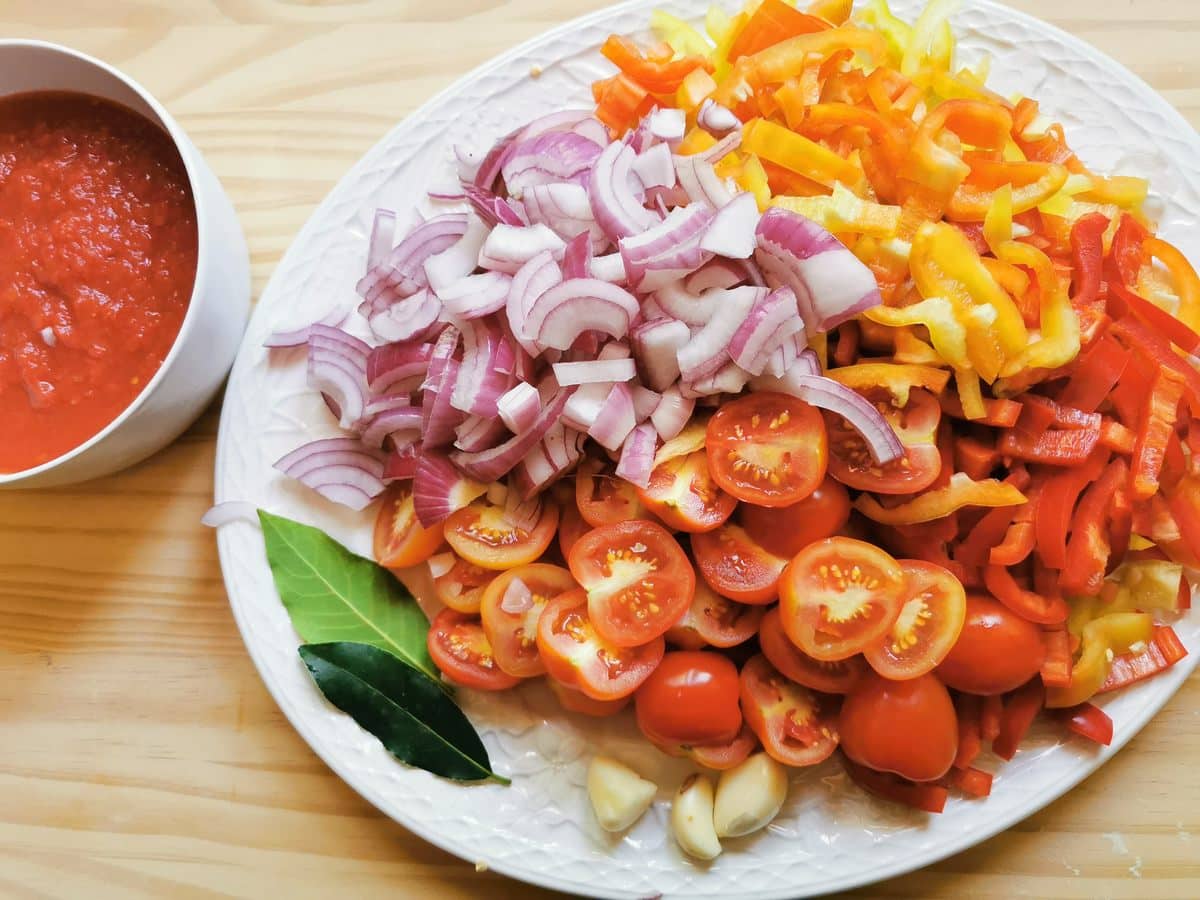 Peppers, tomatoes, garlic and onions prepared for the sweet pepper sauce.