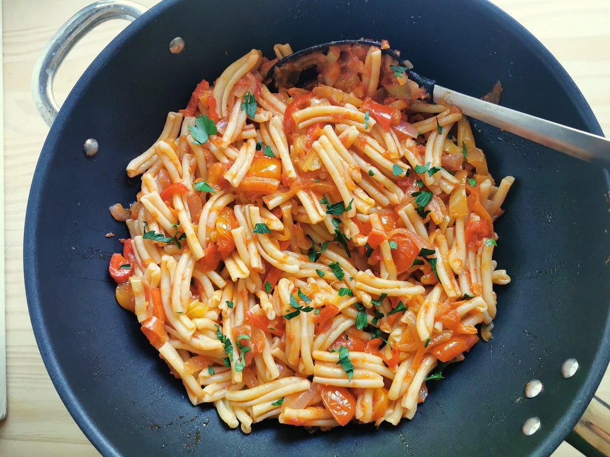 Pasta with a sweet pepper sauce in a pan.