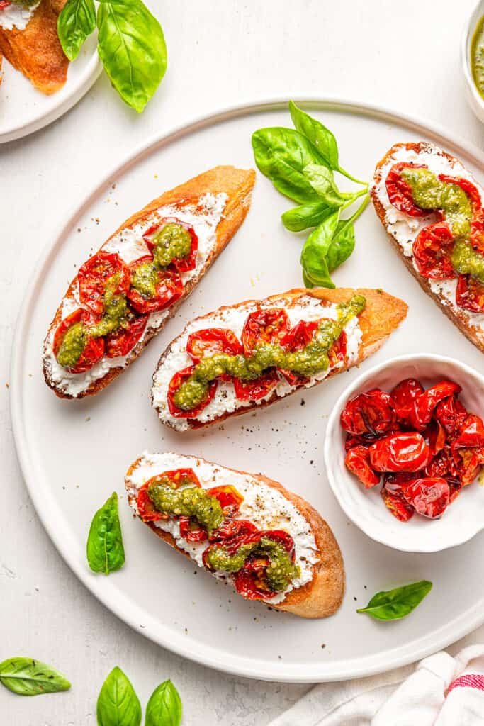 Pesto Ricotta Crostini with Roasted Cherry Tomatoes - The Savory Cipolla
