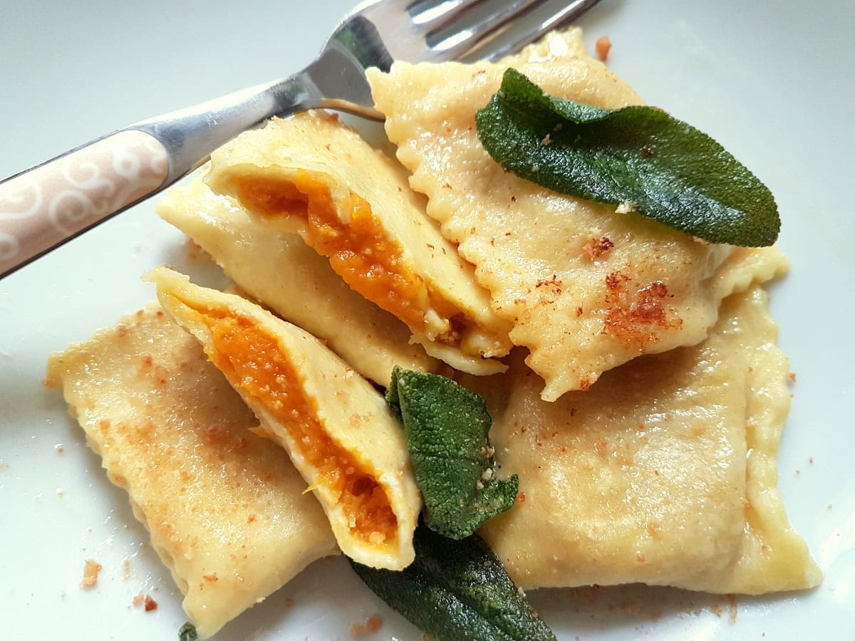 Pumpkin tortelli from Mantova in white bowl.