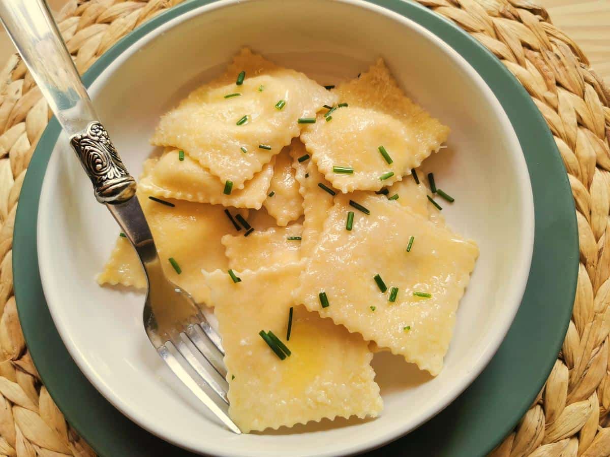 Robiola filled ravioli from Lombardy in a white bowl.