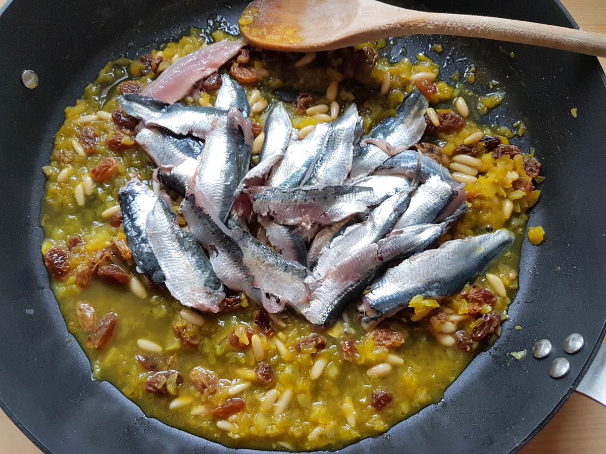 Adding sardines to the sauce