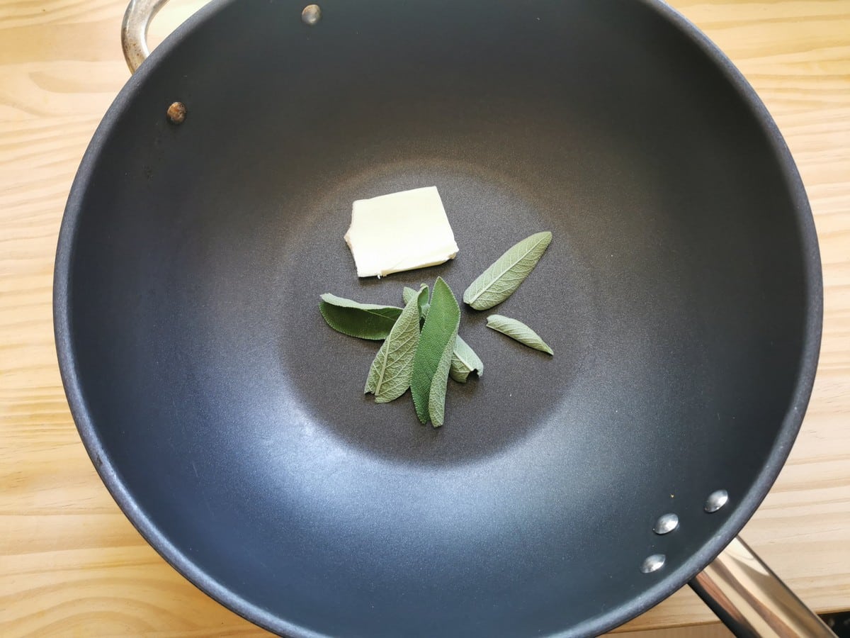 Butter and fresh sage leaves in deep frying pan.