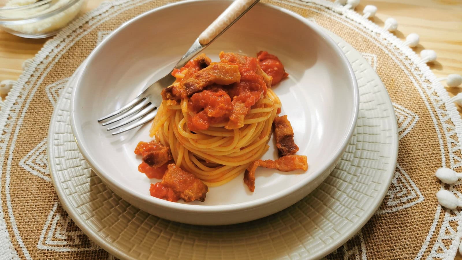 Pasta amatriciana in a bowl on a kitchen table.