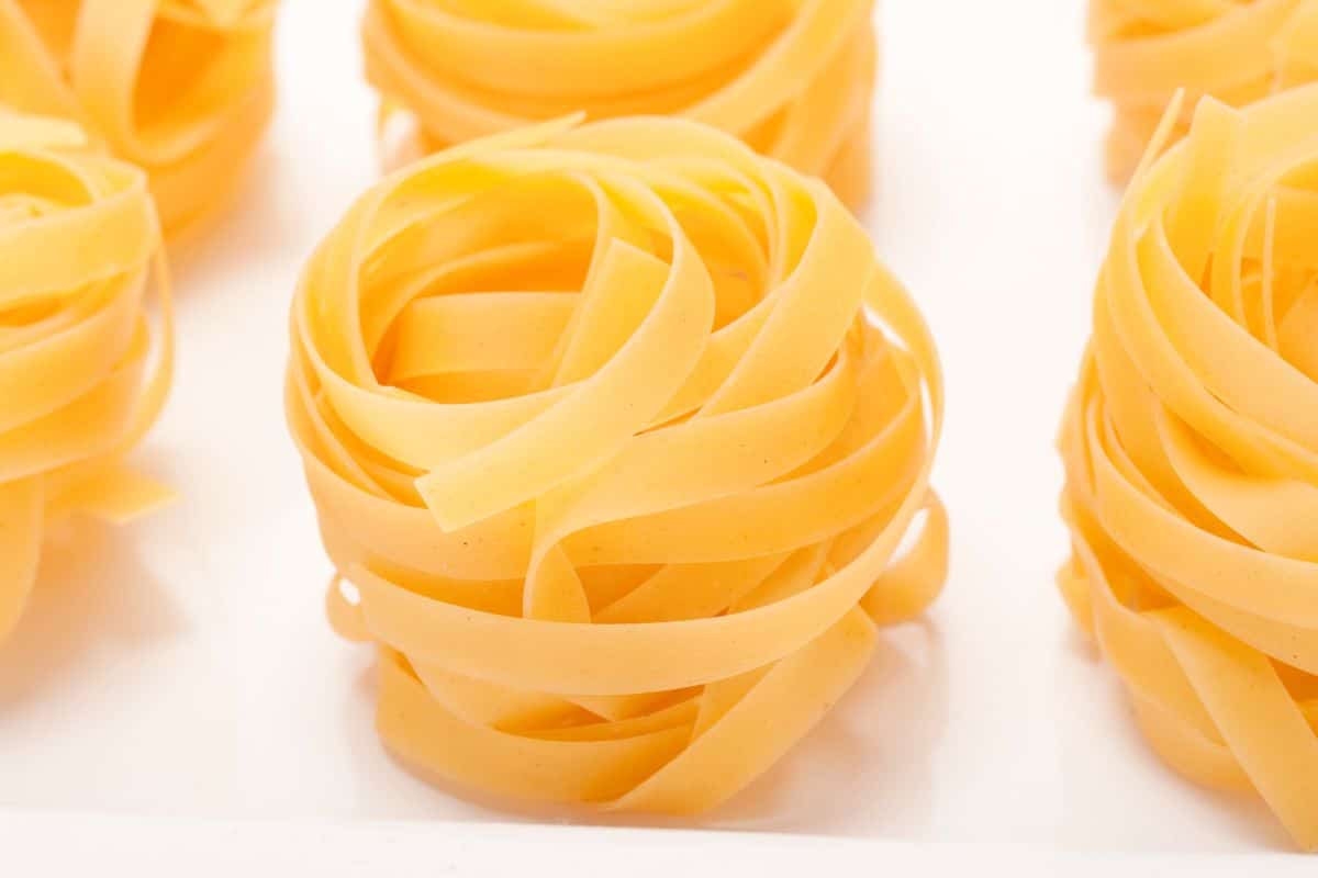Tagliatelle nests on a board.