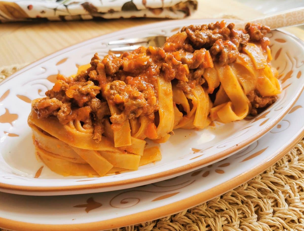 Tagliatelle bolognese on a plate.